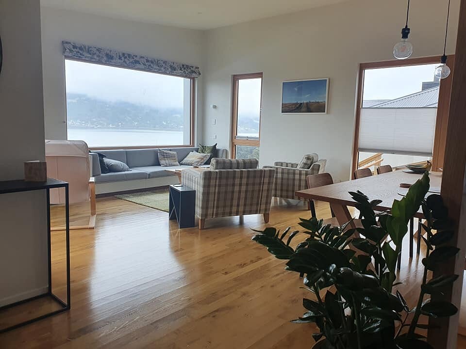 Finished lounge in a C Marshall Builders home looking out over Otago Harbour